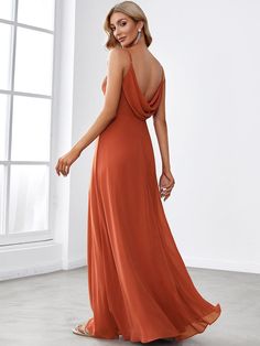 a woman in an orange dress looking back