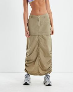 The Mirabel Low Zip Off Tech Cargo Skirt by Insight is a maxi length and features a convertible feature that turns the design into a mini skirt. The skirt comes in a beige colourway and features a zipper fly, two slip pockets, rear slit, two cargo-style back pockets, button fastening, belt loops and ruched detailing by the ankle. Pair it back with a white tank and sneakers for a modern street look..Our model is wearing a size small. She is 176cm with a 84cm bust, a 58cm waist and 84cm hips. Teen Shopping, Cargo Skirt, Street Look, Maxi Skirts, White Tank, Skirted Swimwear, Denim Shop, T Shirt Top, Denim Women