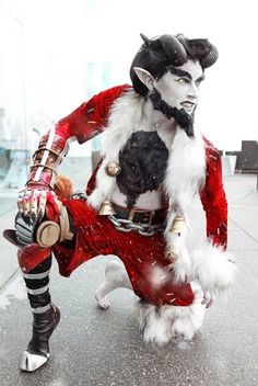 a man dressed in costume is walking down the street with his hand on his hip