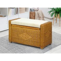 a wicker storage box with a cushion on the top and floor next to it