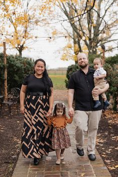 a family walking down a path in the fall