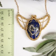 Lapis Lazuli Scarab-inspired Pendant gilded in rich, golden-plated copper wire! Unleash your inner beetle and take flight! Unique Gold Jewelry With Lapis Lazuli, Gold Bohemian Jewelry With Lapis Lazuli, Scarab Wire Wrap, Luxury Wire Wrapped Spiritual Jewelry, Bohemian Gold Lapis Lazuli Jewelry, Gold Bohemian Lapis Lazuli Jewelry, Spiritual Brass Wire Wrapped Necklace, Bohemian Gold Lapis Lazuli Necklace, Bohemian Lapis Lazuli Wire Wrapped Jewelry