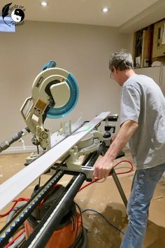 a man standing in front of a table sawing