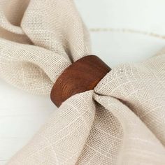 a close up of a wooden bow tie on a white plate with burlock