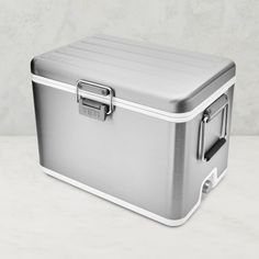 a silver and white cooler sitting on top of a table