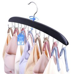 several bras hang on hooks in front of a white background with a blue tag