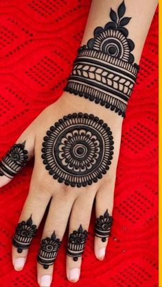 a woman's hand with henna tattoos on it