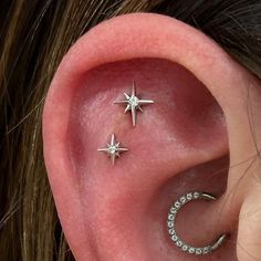 two small stars are attached to the ear