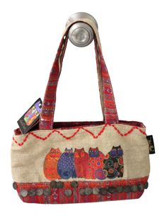 Laurel Burch 5 Cat Canvas Bag Zipper Small Tote Handbag Purse New with attached tag  Pretty small size 5 cats on one side & the other side reads "HEAL HEARTS, EMBRACE, SPRITS with picture of cat Laurel Burch  Round metal accents in multi-color  Fabric is canvas  Soft canvas handles with a 9 1/2" strap drop Bottom of tote is hard When laying flat measures around 13" width across bag x 7 1/4" height top to bottom x 4" width bottom Top zipper closure with a metal cat pull on red zipper Interior is Picture Of Cat, Groovy Clothes, 5 Cats, Metal Cat, Cats Tote Bag, Digital Closet, Cat Tote, Funky Outfits, Unique Purses