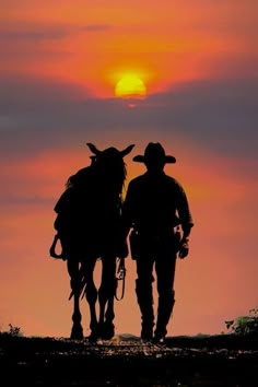 two cowboys are walking through the sunset with their backs to each other as they ride horses