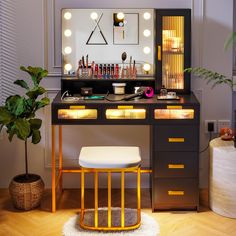 a vanity with lights on it and a stool in front of the mirror that is lit up