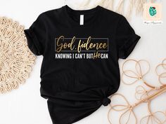 a black t - shirt with gold lettering that says, god evidence knows i can't buy ocean