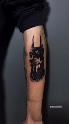 a man's arm with a tattoo on it that has an image of a dog