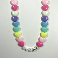 "You have just found the perfect gift for birthdays or Easter! This cute pastel, retro HEART necklace can come personalized or with hearts only. This 16\" stretchy necklace fits right over your head so it's easy to put on- no clasps needed. The matching bracelet is listed here: https://www.etsy.com/listing/909362079/kids-heart-bracelet-party-favor-girls?ref=shop_home_active_5&frs=1 Please check all selections and spelling prior to check out. Our custom jewelry is made to order so all sales a White Heart Necklace With Charm For Birthday, Personalized Playful White Necklace, White Heart Necklace For Birthday And Valentine's Day, Playful Personalized White Necklace, White Necklace With Heart Charm For Birthday, Letter Beads Necklace For Birthday And Valentine's Day, Cute Personalized Heart Necklace For Mother's Day, White Heart Charm Necklace For Birthday, White Heart Necklace For Birthday