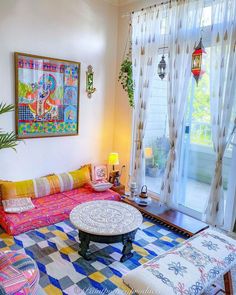 a living room filled with furniture next to a window