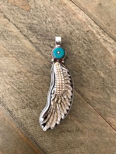 Bone feather pendant in Tibetan silver set with turquoise. It is approximately 69X19 mm including bail and weighs about 13 gm. Images may appear enlarged or smaller, please refer to the measurements given. Turquoise Amulet Necklace With Large Pendant, Turquoise Amulet Jewelry Collectible, Hand-strung Turquoise Pendant Jewelry, Silver Feather Pendant Jewelry, Spiritual One-of-a-kind Turquoise Pendant Necklace, Multicolor Turquoise Pendant Necklace, Spiritual Style, Feather Pendant, Himalayan, Tibet