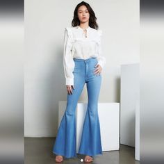 A Pair Of High-Waisted Jeans Featuring An Exaggerated Flare Leg, Zip-Fly Closure, Two Back Patch Pockets, Back Seam Detail, And Raw Cut Hem. Approx Measurements Waits 15.5" (5)Inseam: 33”, Rise: 12” Model Is 5’8" 49% Siro Rayon, 32% Cotton, 17% Polyester, 2% Spandex Machine Wash Cold Like Colors Only Made In The U.S.A New Size 31 Usa News, Back Patch, High Waist Jeans, Flare Jeans, Patch Pocket, Retro Vintage, Wide Leg, Women Jeans, High Waisted