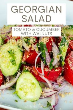 a salad with tomatoes, cucumber and onions is shown on a white plate