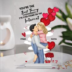 a couple hugging each other in front of a valentine's day card with hearts