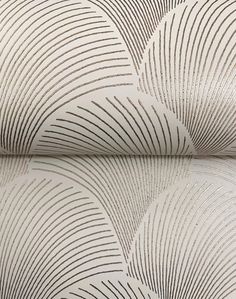 a white and brown wallpaper with wavy lines