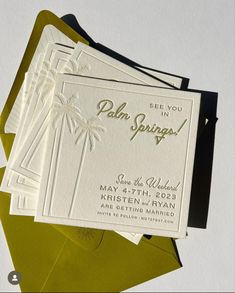 some cards are laying on top of an envelope with the word palm springs printed on them