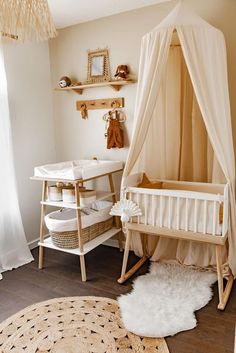 a baby's room with a crib, table and rugs on the floor