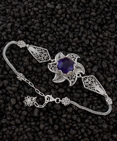 Amethyst Silver Filigree Lotus Flower Bracelet, 925 Sterling Silver Handmade Artisan Crafted Purple Floral Ornate Women Chain Bracelet February bracelet, birthstone bracelet, silver gift for her Gemstone: Amethyst 12mm. Material: 925 Sterling Silver ( NICKEL FREE ) Bracelet Length: 18 cm + 5 cm // 7 Inches + 2 Inches Extender Bracelets Width: 2.5 cm // 1 Inches Adorn your wrist with the ethereal elegance of the Amethyst Silver Filigree Lotus Flower Bracelet. Meticulously handcrafted from the finest 925 sterling silver, this bracelet is a testament to artisanal mastery and timeless craftsmanship. Its delicate chain, a seamless fusion of art and intricacy, drapes like a whisper of beauty around your wrist. At its heart blooms a resplendent lotus, meticulously fashioned with intricate filigre Elegant Silver Gemstone Charm Bracelet, Sterling Silver Purple Jewelry With Intricate Design, Purple Sterling Silver Jewelry With Intricate Design, Sterling Silver Jewelry With Intricate Design In Purple, Ornate Silver Amethyst Jewelry, Traditional Sterling Silver Gemstone Bracelet, Elegant Purple Chain Bracelet As Gift, Traditional Purple Jewelry For Formal Occasions, Traditional Sterling Silver Gemstone Bracelets