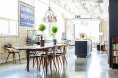 a dining room table and chairs in front of a bookshelf filled with books