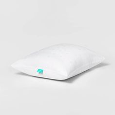 a white pillow sitting on top of a table