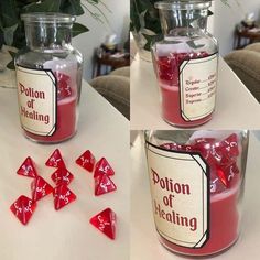 three jars with red dices sitting on top of a table next to each other