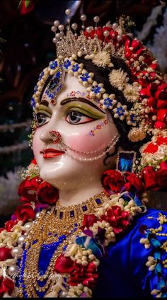 a close up of a mask with flowers on it