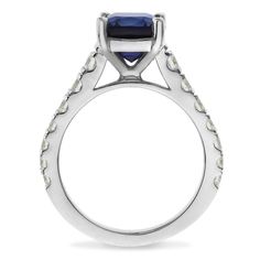 a white gold ring with a blue sapphire and diamonds on the side, set in 18k white gold