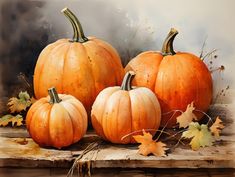 three pumpkins sitting on top of a wooden table