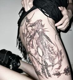 a woman with tattoos on her thigh and legs