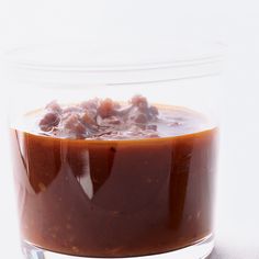 a glass bowl filled with sauce on top of a table