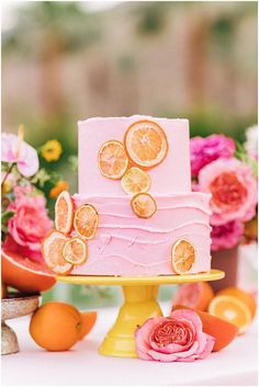 a three tiered cake with orange slices on it