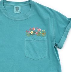 Comfort Colors Embroidered crewneck wildflower pocket tshirt. Embroidered flower shirt. Flower Boho Shirt. Gift for her or Girlfriend Gift. PLEASE NOTE THAT THE PICTURES ON THE LISTING ARE SAMPLES ONLY. If interested in adding embroidery to the sleeve please go to this listing: https://www.etsy.com/listing/1674502020 Because it is made to order, we don't accept the return or exchange unless we make a mistake We are unable to replace or refund purchases based on the color and the font selections. Wildflower Pocket Shirt Embroidered, Green Spring T-shirt With Pockets, Green Pocket T-shirt For Spring, Green T-shirt With Pockets For Spring, Floral Applique Short Sleeve Top In Relaxed Fit, Spring T-shirt With Pockets And Relaxed Fit, Casual Crew Neck T-shirt With Floral Applique, Cute Crew Neck Top With Pockets, Spring Casual T-shirt With Floral Applique