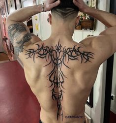 a man with a tattoo on his back