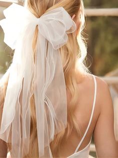 the back of a woman's head wearing a white veil