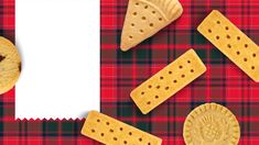 some crackers are laying on a red and black checkered table cloth with a white paper in the middle