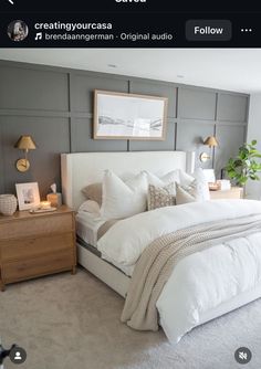 a large bed sitting in a bedroom next to a nightstand and lamp on top of a dresser