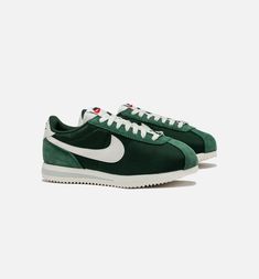 Dressed in a Fir, Sail, and Light Silver color scheme. This offering of the Nike Cortez features a full Fir (Green) base constructed with a nylon upper and suede overlays. Other details includes White leather Swooshes and heel tabs with matching White tongues and insole branding. Embroidered “Nike” branded heels atop a White midsole with Light Silver stripe and Sail rubber outsole completes the design. Cortez Sneakers, Silver Color Scheme, Timberland 6, Mesh Socks, Constantly Evolving, Saint Laurent Sunglasses, Track Shoes, Casual Sneakers Women, Liner Socks