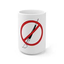 a white coffee mug with a needle in it