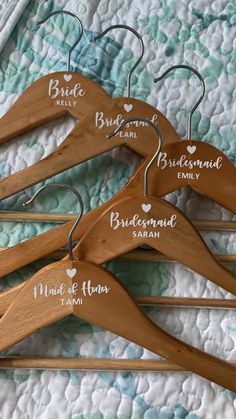 four wooden hangers with names on them