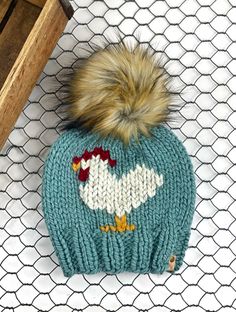 a knitted hat with a chicken on it