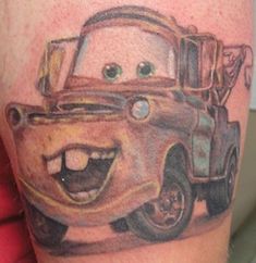 a cartoon character is on the arm of a man with a tattoo that looks like a tow truck