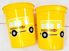 two yellow plastic containers with school bus decals on them