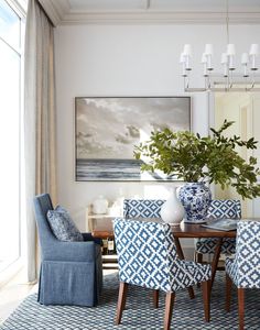 a dining room with blue and white chairs