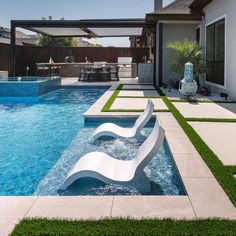 an outdoor swimming pool with artificial grass around it