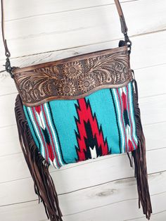 "Wool Aztec designed with beautiful tooled leather and matching tooled strap. one zipper and 2 open pockets inside carried conceal on back 16\"H x 15\" W zipper closer on top zipper pocket and 2 open pockets insideNot customizable - handmade by American Darling Products" Turquoise Hand Tooled Everyday Bags, Hand Tooled Turquoise Bag For Everyday Use, Turquoise Hand Tooled Bags For Everyday Use, Turquoise Hand Tooled Travel Bag, Hand Tooled Turquoise Shoulder Bag For Everyday Use, Turquoise Hand Tooled Shoulder Bag For Everyday Use, Turquoise Hand Tooled Shoulder Bag For Travel, Hand-tooled Blue Crossbody Shoulder Bag, Country Girl Style Outfits